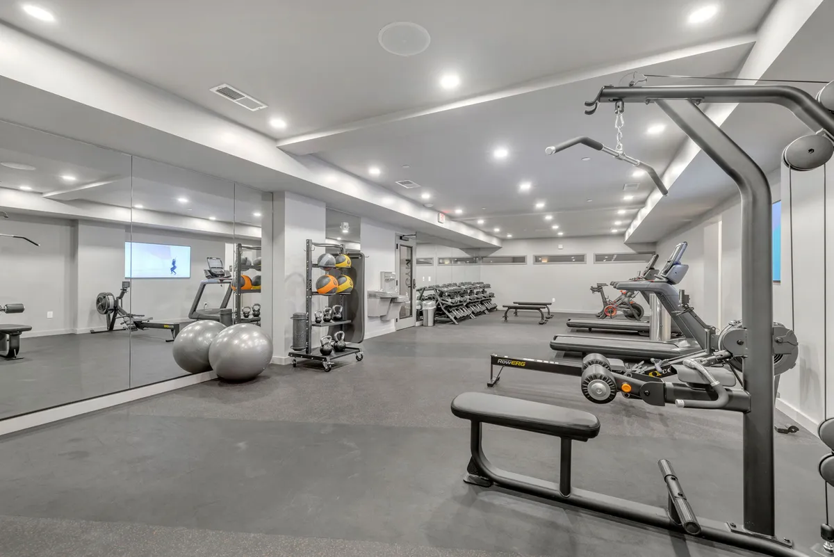A well-equipped, modern fitness center showcases exercise equipment, mirrors, and gym balls, set in a bright, motivating environment ideal for personal or group workouts.