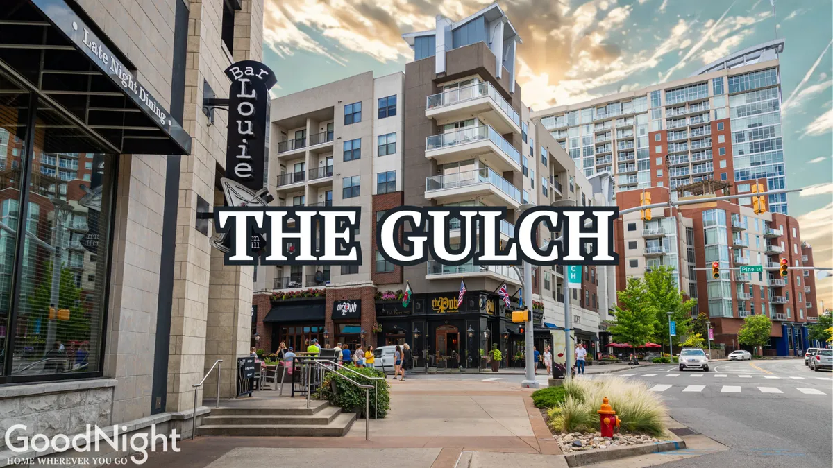 A vibrant city street in The Gulch, one of Nashville’s trendiest districts. The image features modern apartment buildings, pedestrians, outdoor dining at Bar Louie, street signs, and a lively, social atmosphere.